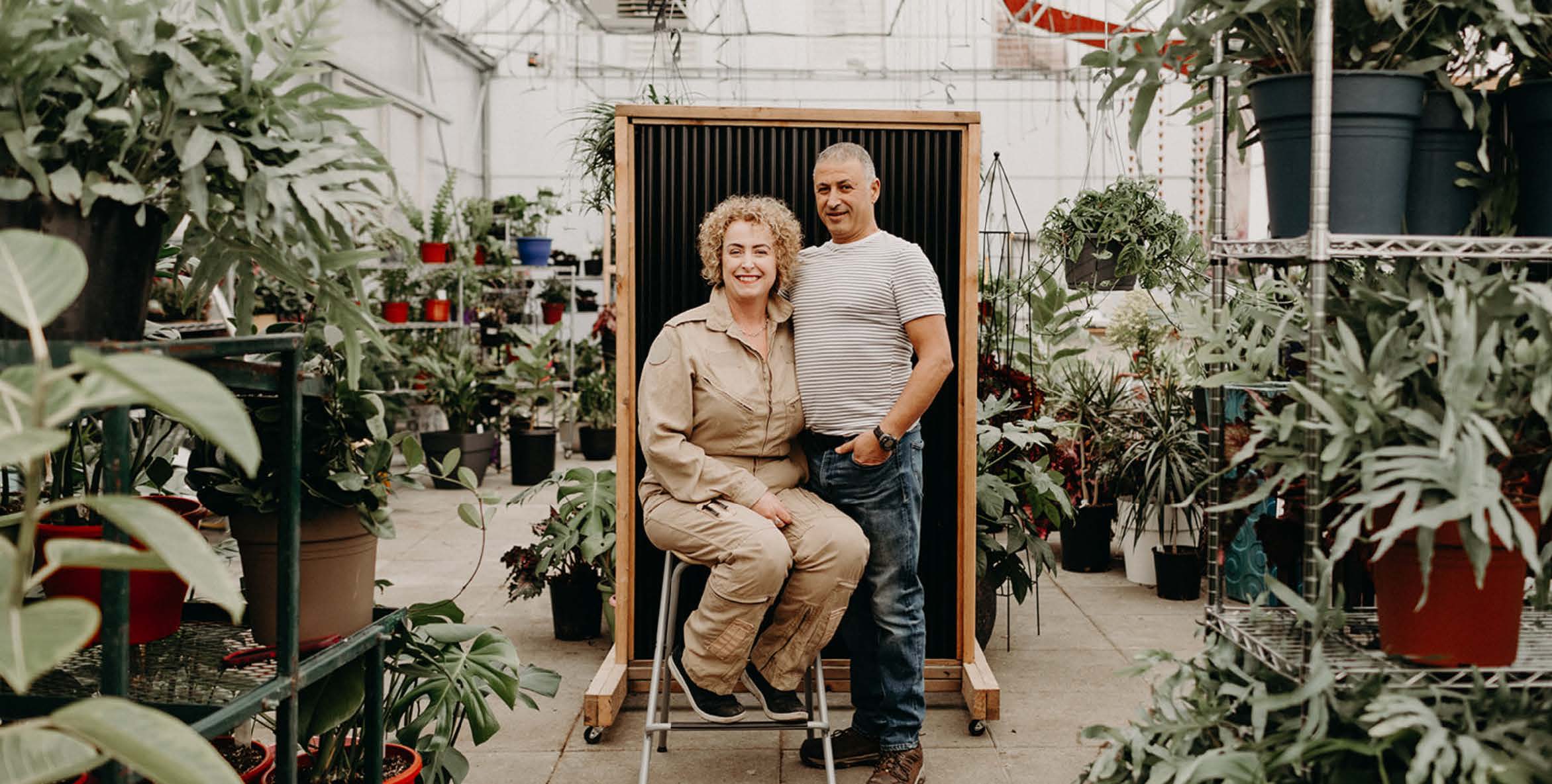 Kelly and Eko, the owners of Down to Earth Landscaping, sitting in the nursery